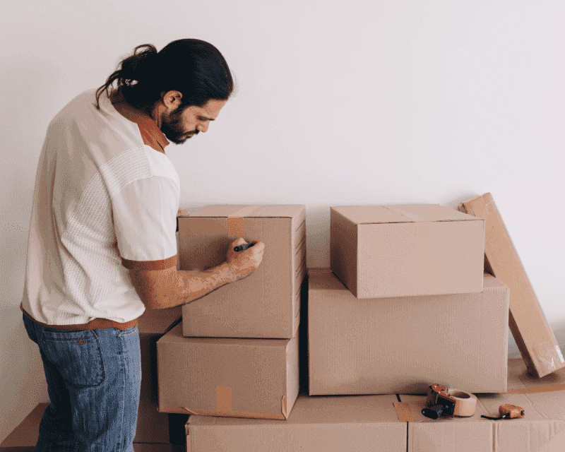 Storage Solutions in Utah: The Best Guide to Storing Smarter 11 a man labeling items for moving