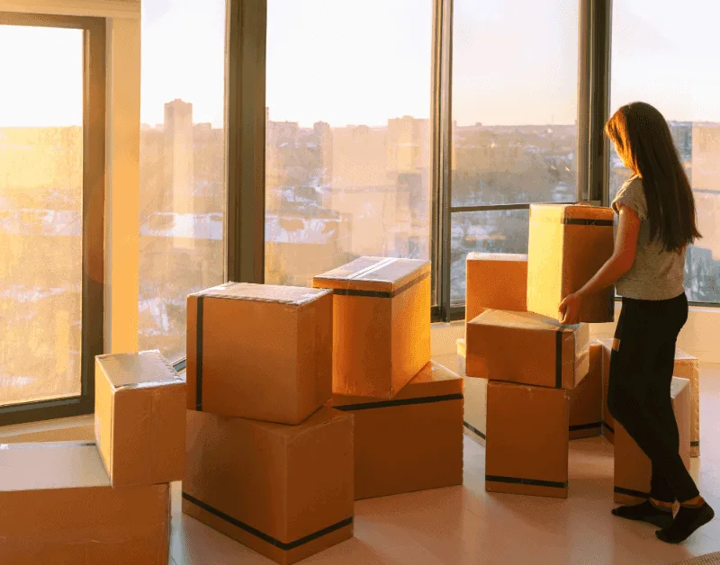 Moving to a Different Climate: A Guide from Mesquite, NV to St. George, UT 1 a woman moving to a new apartment with a warmer climate