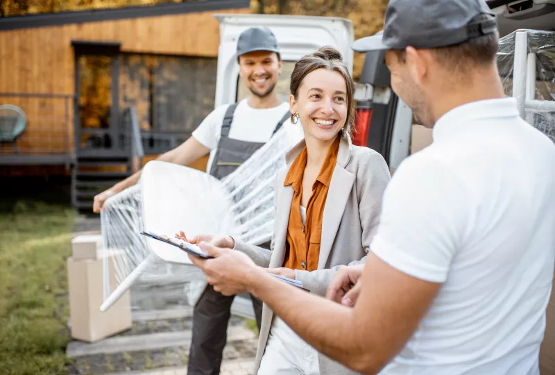 Long Distance Moving: A Comprehensive Guide to Everything You Need to Know 8 A client smiling at her hired professional movers.